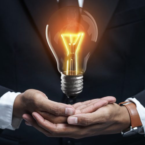 stand-out-idea-concept-with-glowing-bulb-businessman-hand